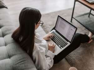Donna al computer mentre confronta diverse proposte di arredamento